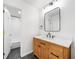 Bright bathroom with wood vanity, white countertop, tile floors, and shower at 4411 Paces Battle Nw, Atlanta, GA 30327