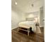 Cozy bedroom featuring wood floors, neutral tones, and a comfortable queen bed with a bench at 4411 Paces Battle Nw, Atlanta, GA 30327