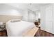 White bedroom with hardwood floors, bed, bench, and mirrored closet at 4411 Paces Battle Nw, Atlanta, GA 30327