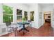 Charming breakfast nook featuring terra cotta floors and multiple windows overlooking the garden at 4411 Paces Battle Nw, Atlanta, GA 30327