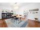Elegant dining room featuring modern chandelier, stylish rug, and view to a bright adjacent kitchen at 4411 Paces Battle Nw, Atlanta, GA 30327