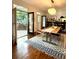 Bright dining room featuring hardwood floors, stylish rug, modern light fixture, and French doors to a patio at 4411 Paces Battle Nw, Atlanta, GA 30327