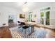 Bright dining room featuring hardwood floors, stylish rug, modern light fixture, and French doors to a patio at 4411 Paces Battle Nw, Atlanta, GA 30327
