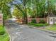 Gated community entrance with brick pillars, lush landscaping, and a guard house adding to the privacy at 4411 Paces Battle Nw, Atlanta, GA 30327