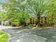 Brick home with symmetrical facade, situated on a landscaped lot with mature trees providing shade at 4411 Paces Battle Nw, Atlanta, GA 30327