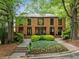 Beautiful brick home with mature trees, lush greenery, and a well-manicured front yard at 4411 Paces Battle Nw, Atlanta, GA 30327