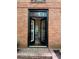 Charming brick home entrance featuring black framed doors with shutter detail and transom windows at 4411 Paces Battle Nw, Atlanta, GA 30327