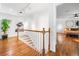 Upstairs hallway with hardwood floors and view into the main bedroom at 4411 Paces Battle Nw, Atlanta, GA 30327