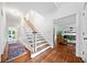 Hallway with hardwood floors, white trim and an open staircase at 4411 Paces Battle Nw, Atlanta, GA 30327