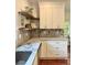 Modern kitchen featuring marble countertops, floating shelves, and stainless sink perfect for cooking and entertaining at 4411 Paces Battle Nw, Atlanta, GA 30327