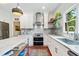 Bright kitchen with marble countertops, stainless steel appliances, and stylish white cabinetry at 4411 Paces Battle Nw, Atlanta, GA 30327