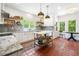 Bright, airy kitchen with white cabinets, marble countertops, an island and terra cotta tile floors at 4411 Paces Battle Nw, Atlanta, GA 30327