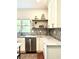 Bright kitchen features stainless steel dishwasher and marble countertops, creating a modern aesthetic at 4411 Paces Battle Nw, Atlanta, GA 30327