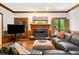 Inviting living room featuring a fireplace, rich wood trim and a comfortable leather sofa at 4411 Paces Battle Nw, Atlanta, GA 30327