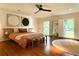 Spacious bedroom featuring a ceiling fan, two windows, and bench seating to create a comfortable retreat at 4411 Paces Battle Nw, Atlanta, GA 30327