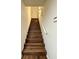 Modern staircase features wooden steps with sleek white walls, enhancing the home's contemporary design at 4411 Paces Battle Nw, Atlanta, GA 30327