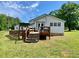 A cozy home featuring a charming wooden deck and a lovely, spacious lawn for outdoor enjoyment at 505 Sandhill Hickory Level Rd, Carrollton, GA 30116