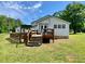 A charming one-story home featuring a wooden deck and a spacious, green backyard with mature trees at 505 Sandhill Hickory Level Rd, Carrollton, GA 30116