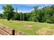 A serene, expansive yard featuring mature trees and distant fencing at 505 Sandhill Hickory Level Rd, Carrollton, GA 30116