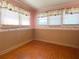 Bedroom with wood floors, three windows, and decorative wallpaper border at 505 Sandhill Hickory Level Rd, Carrollton, GA 30116