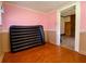 Bedroom featuring wood floors, a doorway, and a large air mattress at 505 Sandhill Hickory Level Rd, Carrollton, GA 30116