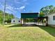 The expansive, covered parking area connecting the main house to the additional structure at 505 Sandhill Hickory Level Rd, Carrollton, GA 30116