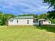 A charming one-story home with a verdant lawn and convenient, attached screened-in porch at 505 Sandhill Hickory Level Rd, Carrollton, GA 30116