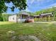 Charming home with a screened-in porch and large covered parking area nestled on a lush green lawn at 505 Sandhill Hickory Level Rd, Carrollton, GA 30116