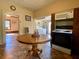 Bright kitchen featuring a round table, appliances, and view into the adjacent utility room with laundry machines at 505 Sandhill Hickory Level Rd, Carrollton, GA 30116