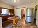 Charming kitchen with a round table, stainless steel refrigerator, and a view to another room through a sliding door at 505 Sandhill Hickory Level Rd, Carrollton, GA 30116
