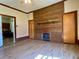 Living room view showcasing a fireplace, wood accent wall, and doorway to another room at 505 Sandhill Hickory Level Rd, Carrollton, GA 30116