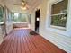 Inviting screened-in porch featuring wood flooring, ceiling fan, and natural light at 505 Sandhill Hickory Level Rd, Carrollton, GA 30116