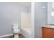 Bathroom features a toilet, tub, and vanity, accented by gray and brown wood-look flooring at 1576 King Mill Rd, Mcdonough, GA 30252