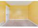 This bedroom features yellow walls, a door and neutral carpet at 1576 King Mill Rd, Mcdonough, GA 30252