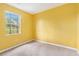 This bedroom features yellow walls, a window and neutral carpet at 1576 King Mill Rd, Mcdonough, GA 30252