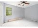 A bright bedroom with a ceiling fan and window that provides natural light ready for your personal touches at 1576 King Mill Rd, Mcdonough, GA 30252