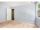 A bedroom with light blue walls features a window and closet in need of flooring at 1576 King Mill Rd, Mcdonough, GA 30252