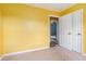 This bedroom features yellow walls, a door and neutral carpet at 1576 King Mill Rd, Mcdonough, GA 30252