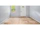 A bedroom features a window and a white door in need of flooring at 1576 King Mill Rd, Mcdonough, GA 30252