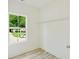 A view of a bedroom with a large window overlooking the lush greenery outside at 1888 Goddard Se St, Atlanta, GA 30315