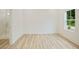 New bedroom featuring modern floors and a window with view to trees outside at 1888 Goddard Se St, Atlanta, GA 30315