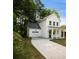 Charming two-story home featuring a front porch with columns, an attached garage, and a concrete driveway at 1888 Goddard Se St, Atlanta, GA 30315