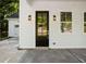 Close-up of the home's front door and covered porch, complete with stylish light fixtures and detailed trim at 1888 Goddard Se St, Atlanta, GA 30315