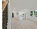 Open-concept living room with light-colored wood floors, modern lighting, and a view of the kitchen at 1888 Goddard Se St, Atlanta, GA 30315