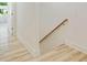 View of new staircase with modern wood-look flooring, white walls and a wood handrail at 1888 Goddard Se St, Atlanta, GA 30315