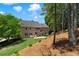 This large backyard has a grass lawn and stone patio, plus a hammock for relaxing at 235 Foxley Way, Roswell, GA 30075