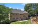 A full backyard with a patio and hammock, green grass and a storage shed at 235 Foxley Way, Roswell, GA 30075