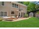 Backyard features a hammock, lush lawn, patio with outdoor furniture, and storage shed at 235 Foxley Way, Roswell, GA 30075