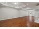 Spacious finished basement with wood flooring, recessed lighting, and a walkout door at 235 Foxley Way, Roswell, GA 30075
