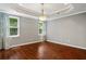 Basement area featuring hardwood floors, large windows, and decorative curtains at 235 Foxley Way, Roswell, GA 30075